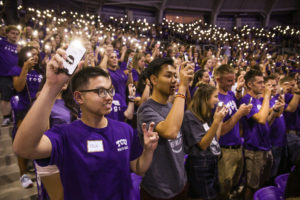 Large group of students holding candles at the Chancellor's Welcome Assembly